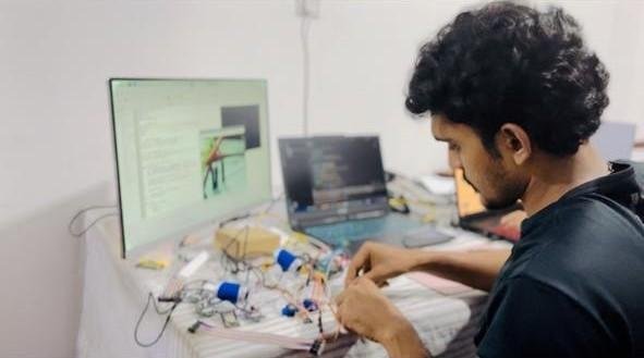 Project team member connecting the prototype electronics at the workbench