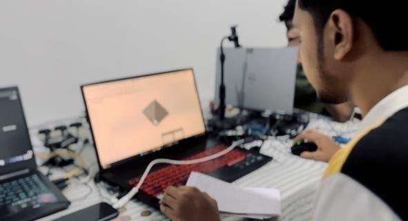 Project member working on the model at a desktop workstation