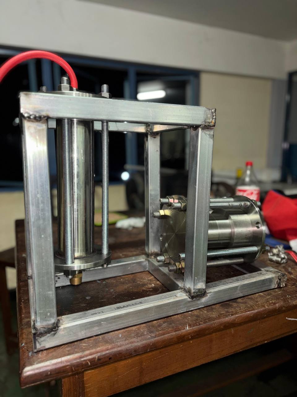 Close view of the Phoenix metal frame, vertical vessel, and horizontally mounted engine